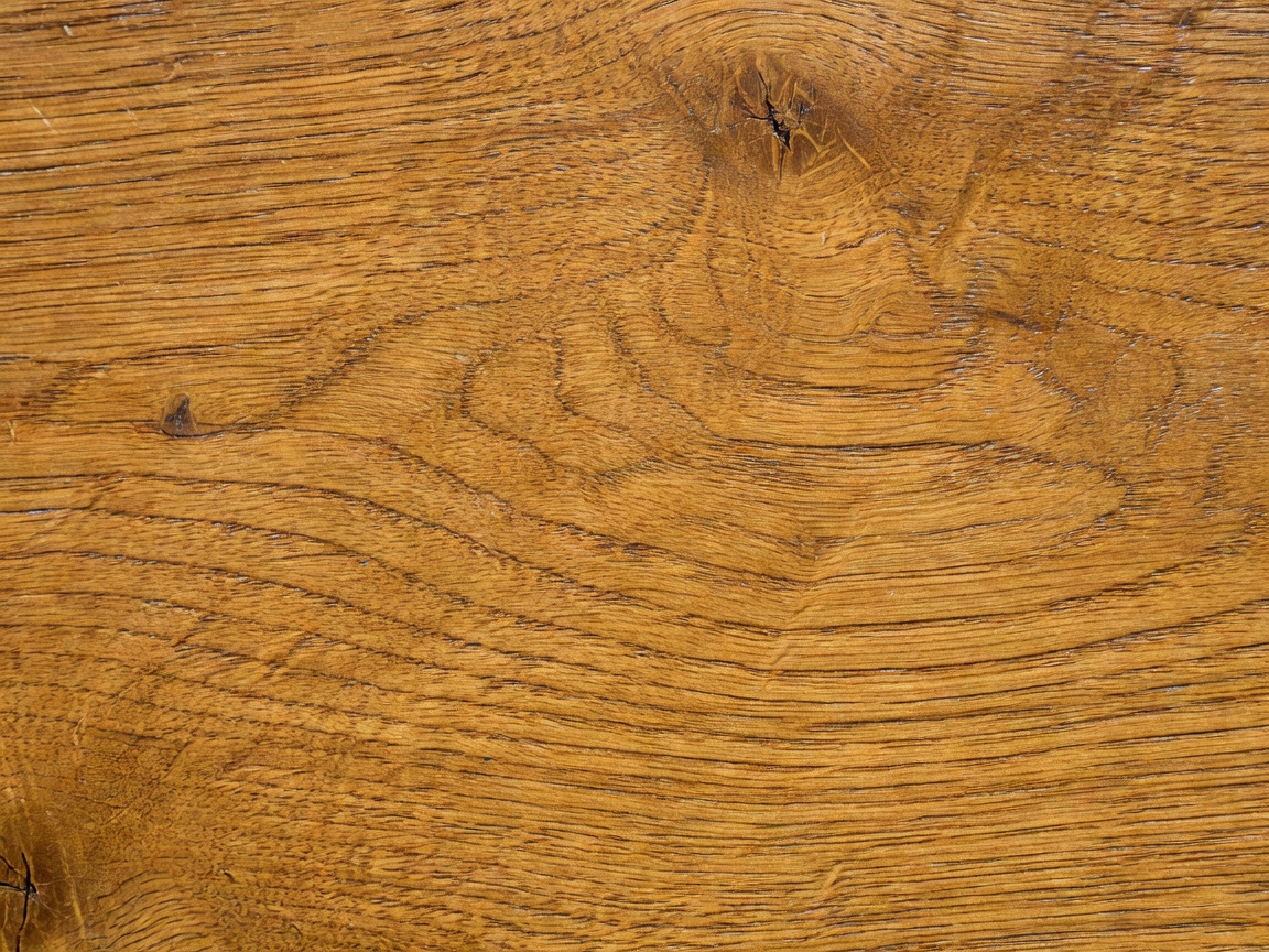 Detailed close up of aged golden oak wood grain texture showing natural wax sheen